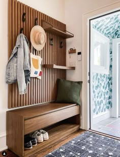 a wooden bench sitting in front of a sliding glass door next to a blue rug