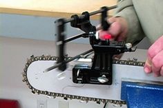 a man is working on a piece of metal with a small device attached to it