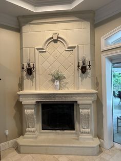 a fireplace with two vases on top of it