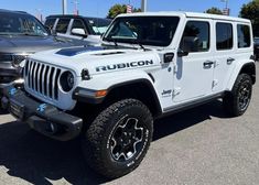 a white jeep parked in a parking lot