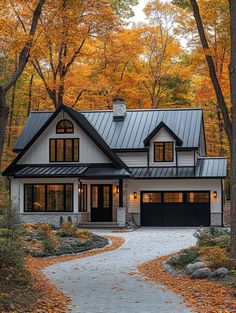 a house in the woods with lots of trees and leaves on the ground around it