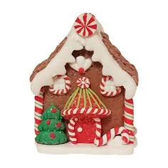 a gingerbread house with candy canes and christmas decorations on the front, white background