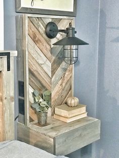 a wooden shelf with a lamp and some books on it next to a wall sign