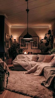 a living room filled with lots of furniture and plants