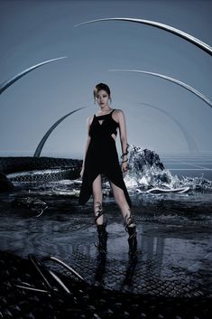 a woman is standing in the water wearing high heels