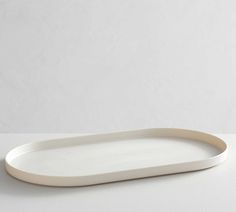 a white oval platter sitting on top of a table