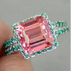 "Specification:- Stone Details :- *Diamond Material : Cubic Zirconia (CZ) *Center Diamond Shape : Emerald Cut *Center Diamond Dimension : 10 MM *Side Diamond Dimension : 1.80 MM *Diamond Color : Green / Pink *Clarity : VVS Procedure information Please select the material and ring size from the drop-down menu on the right side of the listing. If you have any special requests or questions, please do not hesitate to contact us. Details Made to Order Material : 935 SIL/10K/14K/18K We Ship World Wide Princess Cut Jewelry With Side Stones As Gift, Princess Cut Jewelry With Side Stones For Gift, Pink Emerald Ring For Wedding, Pink Emerald Wedding Ring, Pre Engagement, Pink Emerald, Asscher Cut Diamond, Padparadscha Sapphire, Round Diamond Ring