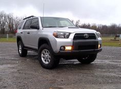 a silver toyota truck parked in a parking lot