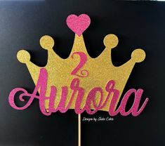 a pink and gold cake topper that says 2 anora with a crown on it