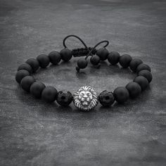 Make a statement with this eye-catching beaded bracelet made with 8mm Black Onyx beads, believed to help increase your inner strength and provide support during times of stress. The centerpiece of this design is a striking 925 Silver lion bead, while the faceted onyx beads next to it add dimension and texture. The adjustable macrame string sliding knot closure makes it easy to wear. Handcrafted with great attention to detail using high-quality materials, this bracelet comes in a stylish black gi Bracelet For Boyfriend, Lion Head Bracelet, Lion Bracelet, Lion Charm, Bracelets For Boyfriend, Top Christmas Gifts, Handcrafted Bracelets, Bracelet Gemstone, Mens Beaded Bracelets