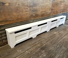 a white shelf sitting on top of a wooden floor