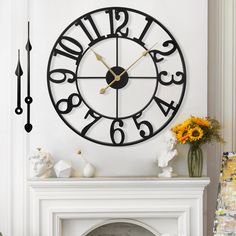 a clock that is on the side of a wall next to a fireplace with flowers