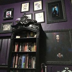 a bookshelf with pictures on the wall