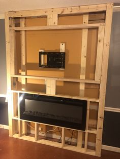 an entertainment center made out of pallet wood with a flat screen tv mounted to the wall