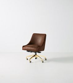 a brown office chair sitting on top of a white floor