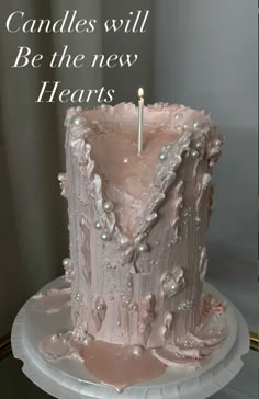 there is a pink cake with pearls and a candle on it that says candles will be the new hearts