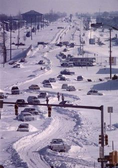 cars are driving on the snow covered road