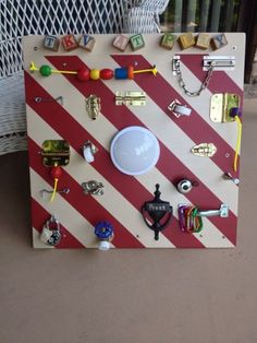 a red and white striped board with lots of different items on it, including keys