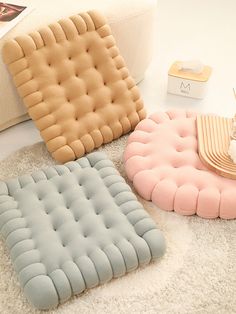 three different types of pillows on the floor