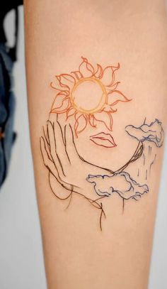 a woman's arm with a sun and clouds tattoo on the left side of her body