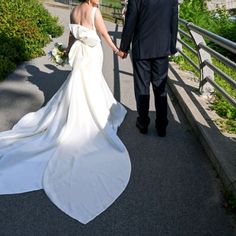 the bride and groom are walking down the path