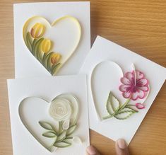 three handmade cards with flowers on them, one has a heart and the other has a flower