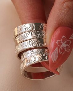 Hand Stamped Birth Flower Wide Ring Bands SOLD INDIVIDUALLY  Sterling Silver or 14K Gold Filled  Width: 4mm Size 4-12 These birth flower designs are all hand stamped one by one so they are one a kind and unique. It may not look perfect meaning the designs may vary slightly from the photos attached. Each design is hand stamped so the flowers may be overlapped or may not be completely stamped. Please note that you are purchasing a handmade piece and not a machine made piece so be open to the ring Ring Bands, Stamped Rings, Wide Ring, Funky Jewelry, Jewelry Lookbook, Birth Flower, Birth Flowers, Dream Jewelry, Jewelry Inspo