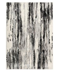 an area rug with black and white stripes on the bottom, along with a light gray background