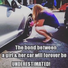 a woman bending over next to a silver car