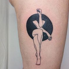 a woman's leg with a tattoo on it that has a black circle around her