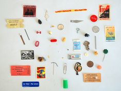 a white refrigerator with magnets and other items on it's side, including pins