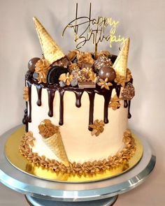 a birthday cake decorated with ice cream and chocolate