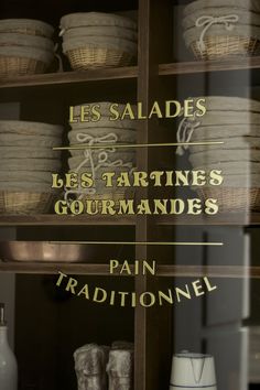 there are many baskets on the shelves in this shop window, and one is for sale