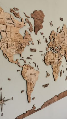 the world map is made out of wooden pieces