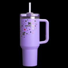 a purple travel mug with stars and unicorns on the side is shown in front of a black background