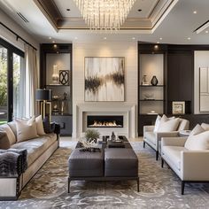 a living room filled with lots of furniture and a chandelier hanging from the ceiling