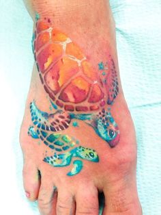 a person with a tattoo on their foot that has a turtle and fish on it