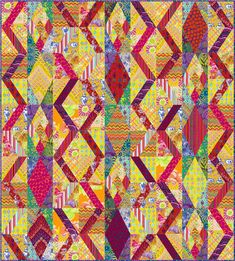 a colorful quilt with many different colors and patterns on the front, side, and back