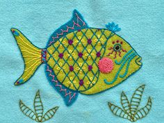 an embroidered fish on a blue background