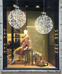 a window display with mannequins and ornaments