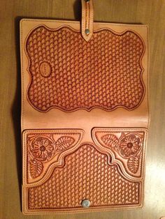 a brown leather case sitting on top of a wooden table