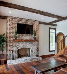 the living room is clean and ready to be used as a tv over the fireplace