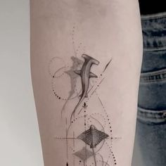 a woman's leg with an abstract tattoo design on the side of her thigh