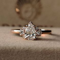 a diamond ring sitting on top of a table