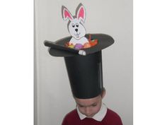 a young boy wearing a black hat with a rabbit on it