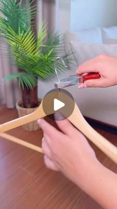 a woman is cutting wood with a pair of scissors