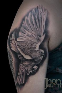 a black and white tattoo with a bird on it