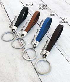 four different types of leather keychains on a white wood floor with names and description