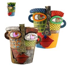 three vases with different designs on them are shown in the shape of faces and eyes