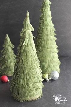 three small green christmas trees sitting next to each other